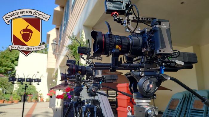 A squadron of cameras on tripods outdoors on a sunny patio