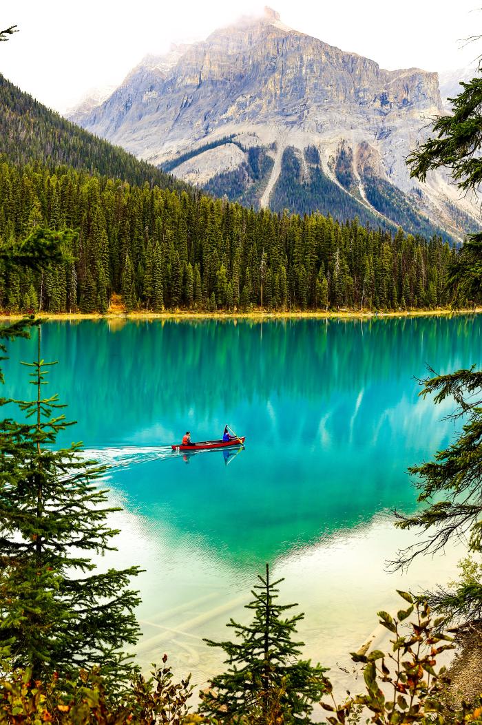 Two people (who are probably not lawyers) row a canoe together on a blue-green lake in an an expansive Canadian wilderness<br>
[photo credit: Steve Hogan]